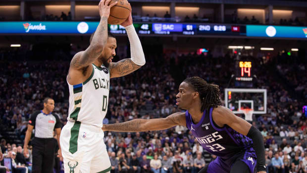 Milwaukee Bucks guard Damian Lillard (0) controls the ball against Sacramento Kings guard Keon Ellis (23)